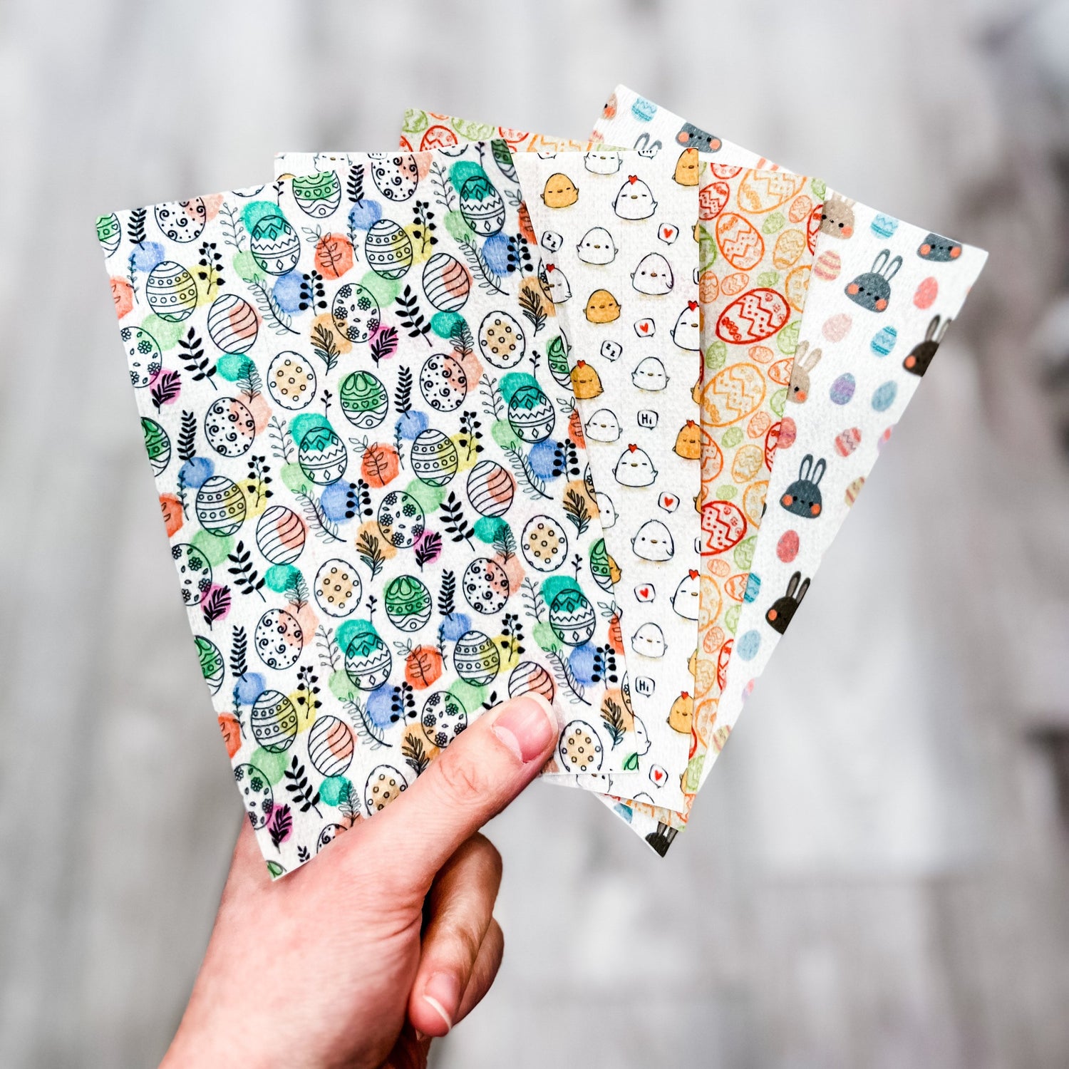 hand holding 4 different easter themed hypafix printed tapes